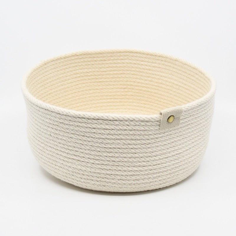 Rope basket sewn from 100% cotton rope, machine sewn and hand dyed in cream shade using plant based dyes handmade by designer Andromeda Nelson on Salt Spring Island. All dye baths are produced in small quantities and every item is a one-of-a-kind piece.