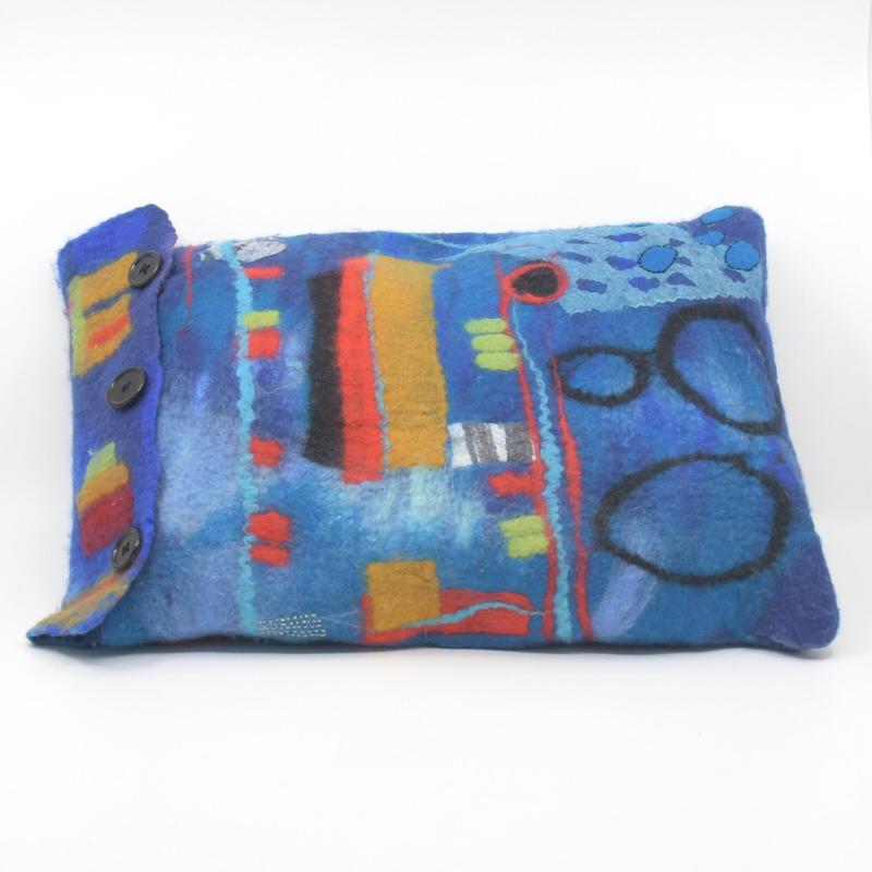 Handmade felt cushion cover in blue merino wool, with cushion included (backside view). Made by Pender Island fibre artist Debbie Katz. 