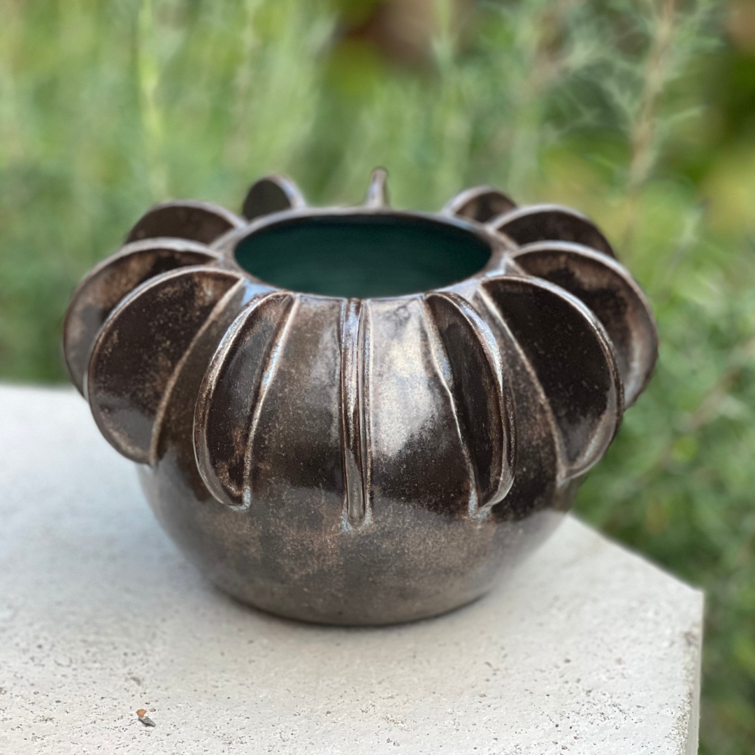 Wheel-thrown high-fired stoneware vase with attached ribs by Salt Spring Island artist Nova Cogswell. Shown outdoors in natural light.